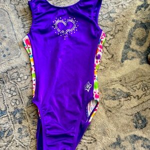 it is purple with silver heart printing and has hearts on the sides